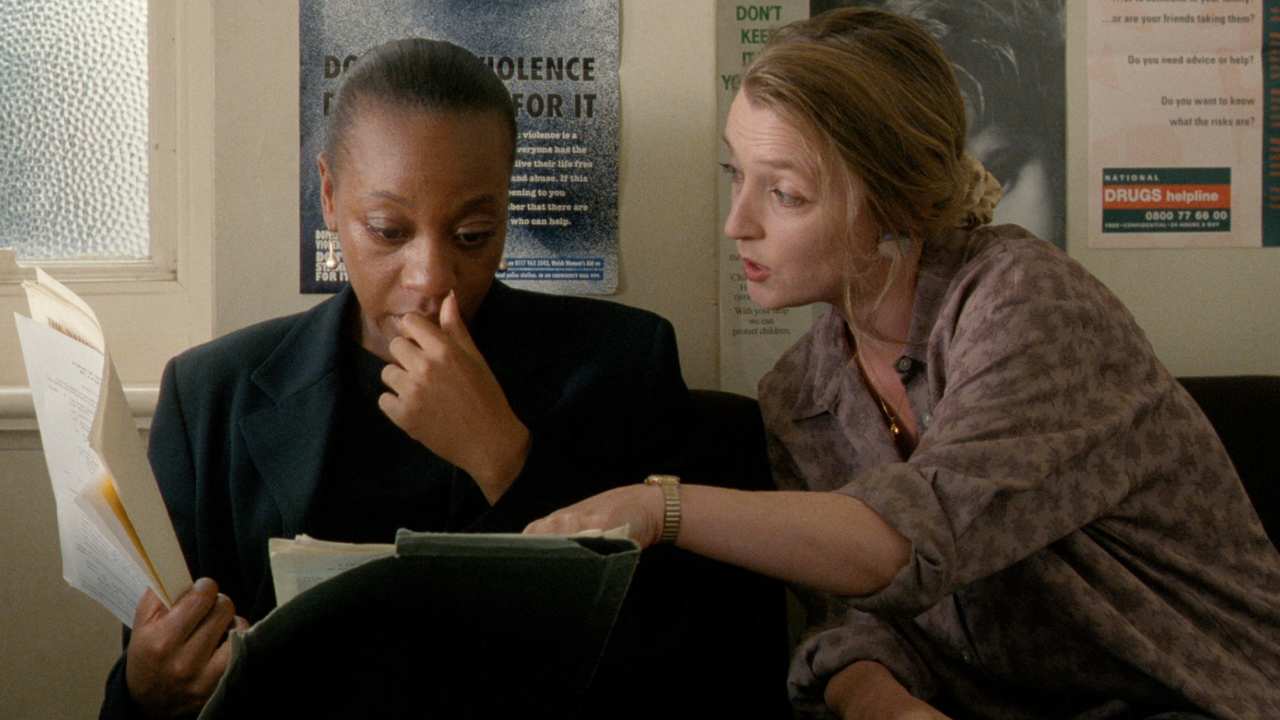 two women looking at papers in an office
